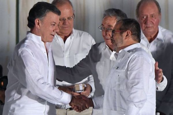 FARC leader Timochenko  and Colombia President Santos shake hands at the Peace agreement ceremony in Cuba in Sept. 2016 